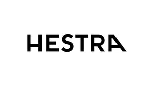 Hestra's bold black logo on white, representing their collection of premium gloves.