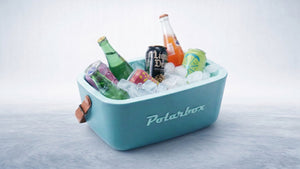 A vibrant light blue cooler packed with ice and diverse refreshing bottled and canned drinks.