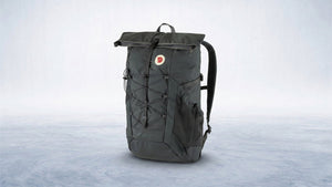 Durable dark grey outdoor backpack with roll-top closure, ready for travel and rugged adventures.