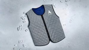Grey quilted cooling vest for women, with blue lining and ice, promising refreshing comfort in warm conditions.