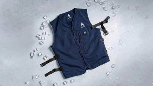 Experience advanced cooling: a navy blue circulatory vest laid on ice, highlighting refreshing comfort and innovative temperature control.