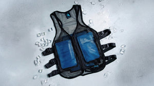 Innovative black mesh ice vests with bright blue gel packs, surrounded by scattered ice on a crisp grey background.
