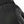 Black mitten by Hestra with an embossed HESTRA logo on textile fabric and a textured leather panel with stitching.