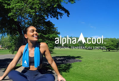 A smiling woman in activewear with a blue cooling towel sits outdoors on a sunny day with green trees and a field. Text: 