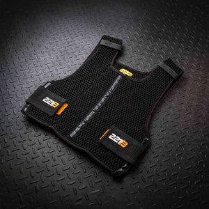 A black mesh training vest with a central zipper, "2213" on orange lower straps, and an "UP-X" label, lies on a dark diamond plate surface.