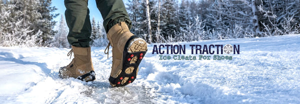 A person in tan boots with black and red ice cleats steps on an icy path, kicking up snow, against a snowy forest. Text: ACTION TRACTION Ice Cleats For Shoes.