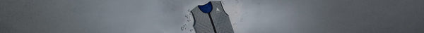 A grey quilted cooling vest with a blue interior and white mountain logo, surrounded by scattered ice cubes, rests on a light grey surface.