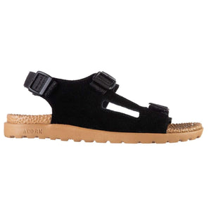 Black suede sport sandal for women by Acorn with adjustable straps, tan sole with Acorn logo, and textured footbed, side view.