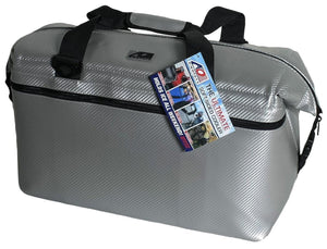 Silver soft-sided cooler by AO Coolers with a carbon fiber pattern, black straps, zipper, and hanging product tag.