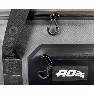 Grey 24 Can Pack Cooler by AO Coolers, with black strap, zippered pocket, and AO logo patch.