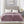 Mauve King-size heated blanket by Beautyrest, made of knitted microlight polyester, draped on a bed with two controllers visible.