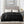 Black 100% polyester solid microlight reversible heated blanket by Beautyrest, draped over a bed with two remote controls.
