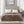 Brown microlight heated blanket by Beautyrest, with a soft texture, draped over a bed with white pillows and dual controls.