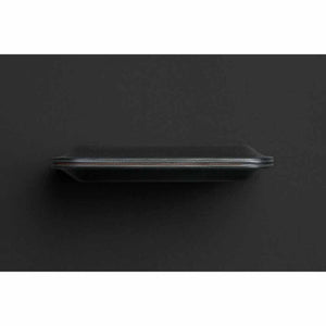 Black Apex Note Sleeve by Bellroy, side view showing its sleek profile and layered multi-colored edges.