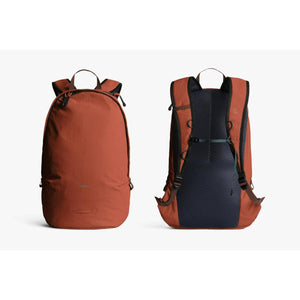 Burnt orange daypack by Bellroy with a minimalist front and a dark mesh back panel, shown from front and back.