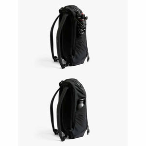 Black Venture Ready Pack by Bellroy, side view, with a tripod and water bottle in its elastic side pocket.