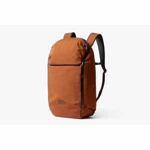 Rust brown fabric backpack by Bellroy with black zippers, a front flap, and padded shoulder straps.