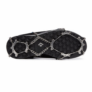 Black and silver spike traction device by Black Diamond attached to the sole of a black hiking shoe.