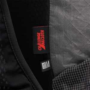 Black technical fabric backpack by Black Diamond, featuring 'CHALLENGE SAILCLOTH' and 'SIZE M' tags, with mesh, woven gray, and grid ripstop panels.