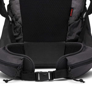 Black grid-patterned backpack by Black Diamond, back view with padded panel, waist belt pockets, and red 'ULTRA' tag.