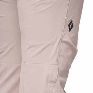 Light pink women's pant by Black Diamond with a black diamond logo and visible seams on the side.