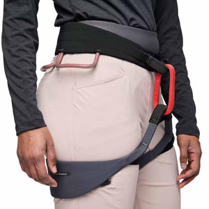 Light beige Women's Alpine Light Pant by Black Diamond, worn with a black, grey, and red climbing harness.