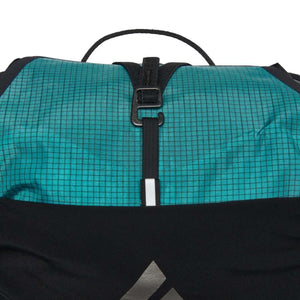 Teal and black Women's Distance 22 Backpack by Black Diamond, with a grid pattern, black strap, silver buckle, and white stripe.