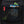 Black women's Distance 22 backpack by Black Diamond, close-up of an open internal mesh pocket with energy bars, carabiner, and red loop.
