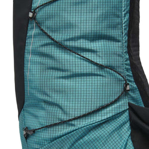 Turquoise ripstop backpack by Black Diamond with a black grid pattern, bungee cord system, and white reflective stripe.