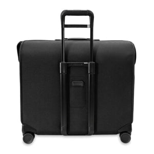 Black Deluxe Wardrobe Spinner by Briggs & Riley, shown from the back with an extended telescoping handle and four wheels.