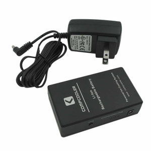 A black rechargeable battery pack by CompCooler with visible text and a connected power adapter.