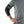 Black elbow brace by DonJoy, worn by a man in a gray t-shirt, showing the side with white logos and straps.