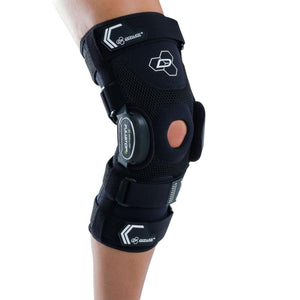 Black Bionic Fullstop knee brace by DonJoy, featuring mesh, adjustable straps, and an open patella, worn on a bent leg.