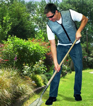 Grey quilted evaporative cooling vest by Chill-Its, worn by a man with sunglasses digging in a garden.
