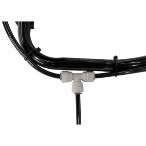 Black misting system tubing and light gray T-connector by ExtremeMIST, with multiple lines connected and secured by black zip ties.