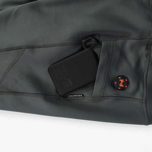 Dark gray Proton Baselayer Heated Pant by Mobile Warming, showing a power bank in a pocket, a Fieldsheer label, and an orange Z logo.