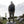 Khaki men's Abisko Trail Stretch regular trousers by FjallRaven, worn by a man on a rock.