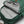 Green backpack by FjallRaven, open to show a grey lining, mesh pocket with keys, and internal sleeves.