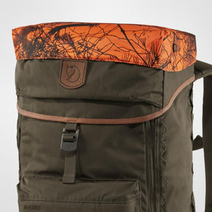 Dark olive robust backpack by FjallRaven, with an orange and black camouflage top flap, brown leather trim, and fox logo patch.