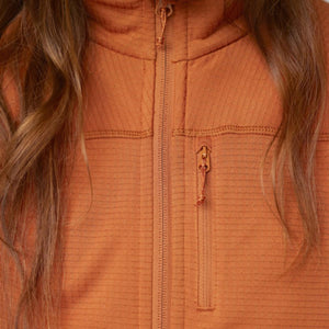 Orange fleece jacket by FjallRaven, featuring a full-zip front, subtle horizontal texture, and zippered chest pocket, with brown hair visible.