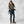 Dark blue women's stretch trousers by FjallRaven, with a slim fit and small fox logo, styled with a grey t-shirt and backpack.