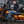 Black heated jacket liner by Gerbing worn by a man on an orange motorcycle.