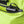 High-vis lime green cooling vest by Gobi Heat with a black power bank and cable inside an open zippered pocket.