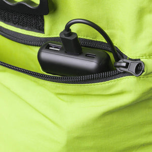 High-vis lime green cooling vest by Gobi Heat with a black power bank and cable inside an open zippered pocket.