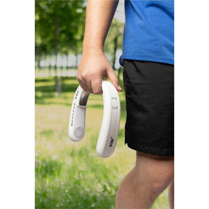 White neck cooling fan by Gobi Heat, held by a person in a blue shirt and black shorts, outdoors.