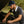 White neck cooling fan by Gobi Heat worn by a man in a dark t-shirt and baseball cap fixing a car engine.