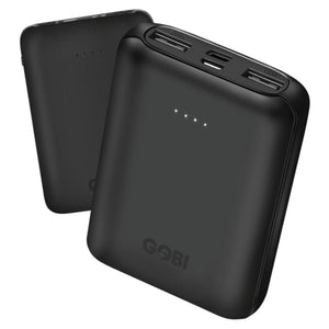 Black power bank by GOBI showing four white LED indicator lights, two USB output ports, and a second unit blurred in the background.