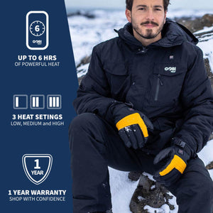 Heated ski gloves in black and yellow by Gobi Heat, worn by a man in a black jacket, seated in snow.