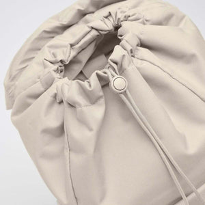 Light beige Flap Pack Bag by Got Bag, showing its cinched drawstring top and cord lock.