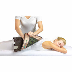 Brown and beige mesh JT pad by HealthyLine with green and black circular elements, applied to a person's lower back.
